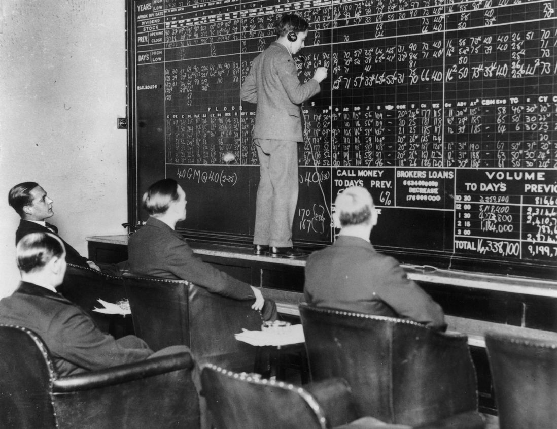 In a London club run by St Phalle Ltd, members watch fluctuations in the New York stock market during the Wall Street crash as changes are chalked up by telephone operators in direct contact with New York.<br/>